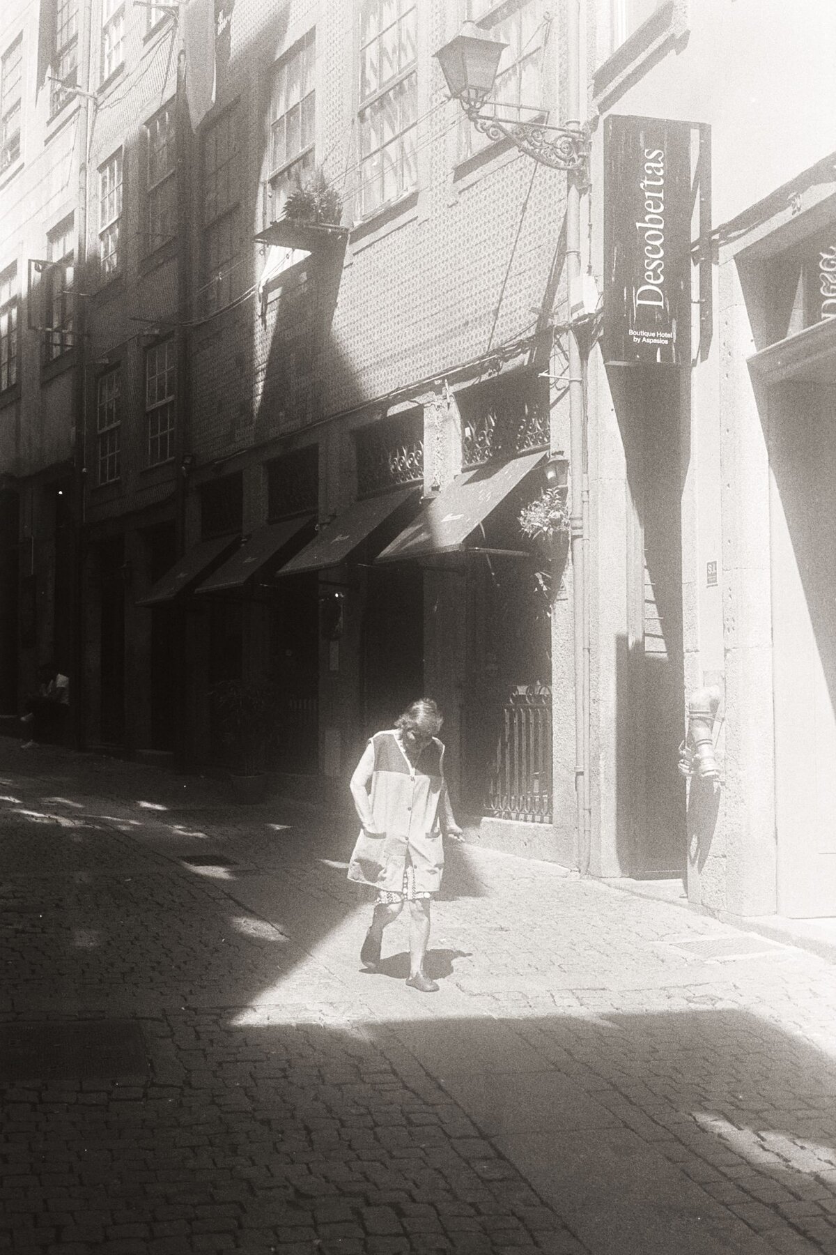 Figure in shadow, bright street