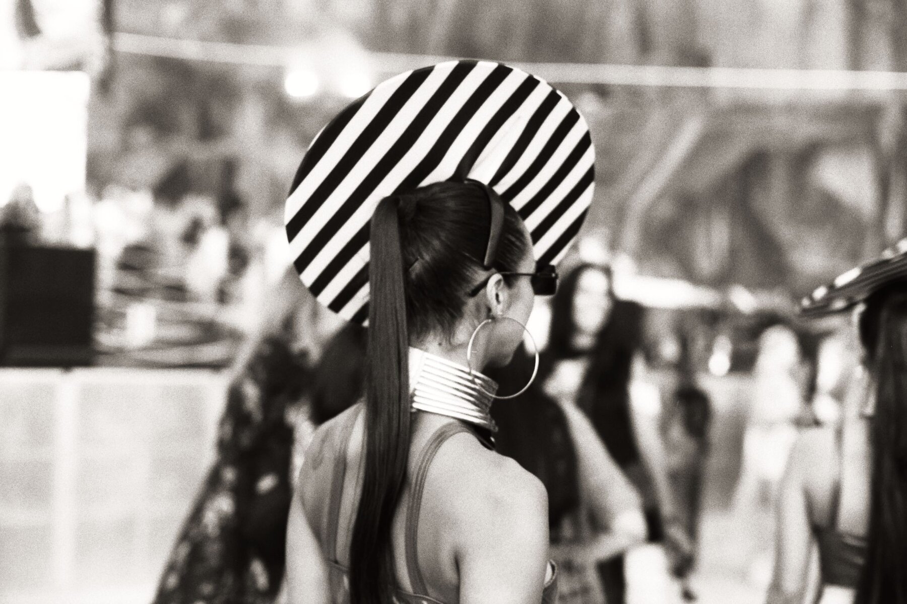 Striped hat, walking away